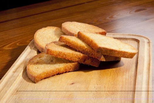 Fresh fried toast on the wooden trench