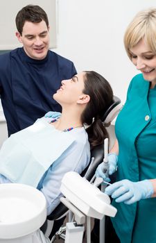 Dentist and his patient talking in examination room