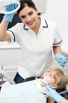 Cute girl undergoing dental treatment at clinic