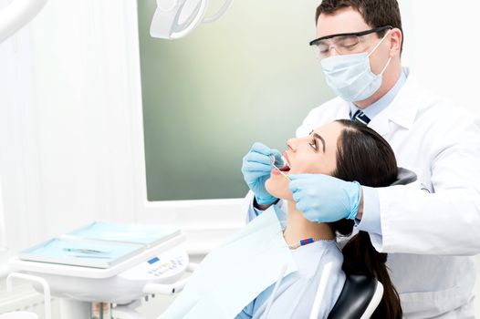 Dental specialist examined female patient teeth