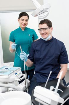 Male dentist with female assistant at dental clinic