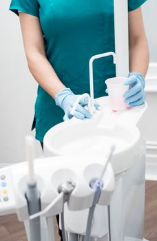 Cropped image of sink in modern dental clinic