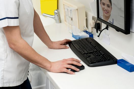 Cropped image of woman appear in computer monitor