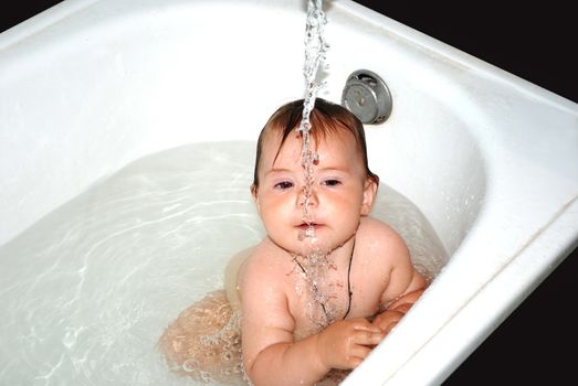 bathing a child under running water