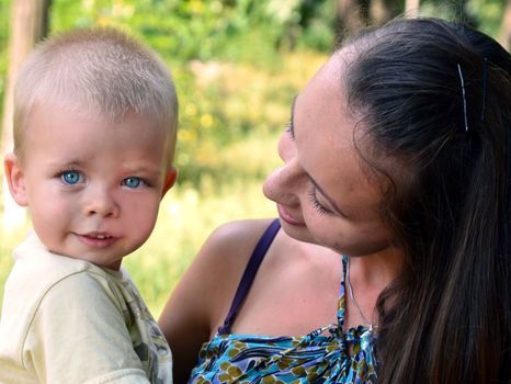 little boy in the arms of a smiling mother