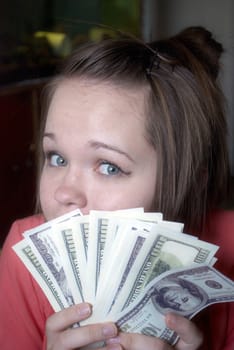 Portrait of young businesswoman with money