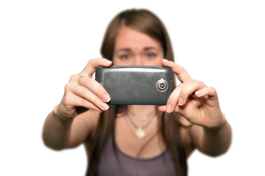 Young woman is taking photos with the mobile phone camera, isolated on white background