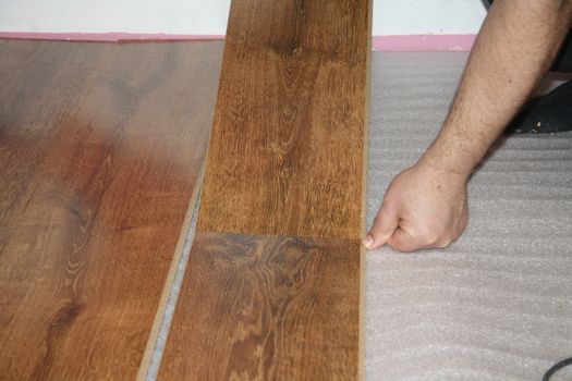 laying a sheet of laminate