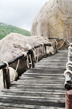 Plank bridge  and huge stones boulders, Koh Nanguan, Thailand