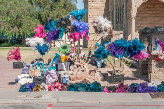 OUDTSHOORN, SOUTH AFRICA - JANUARY 2, 2015: Unidentified vendors selling dusters made from ostrich feathers, a by-product ofthe ostrich industry around the town.