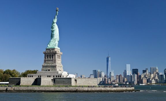 The Statue of Liberty at New York City with the Freedom Tower