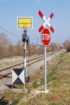 unguarded railway crossing with railways signs