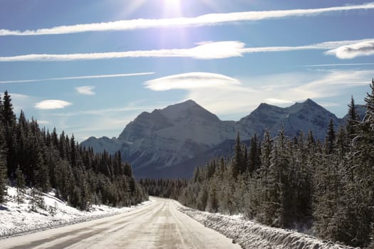 Ice road leading to a mountain under blue sky