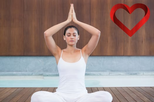 Peaceful woman in white sitting in lotus pose against heart