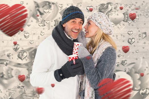 Happy couple in winter fashion holding mugs against grey valentines heart pattern