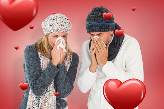 Sick couple in winter fashion sneezing against red vignette