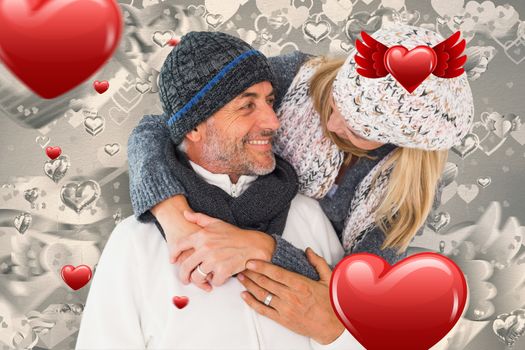 Happy couple in winter fashion embracing against grey valentines heart pattern