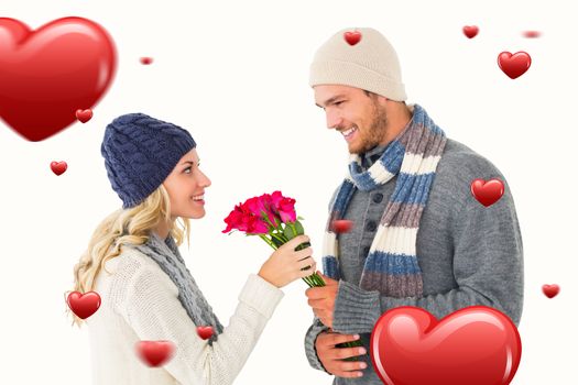 Attractive man in winter fashion offering roses to girlfriend against hearts