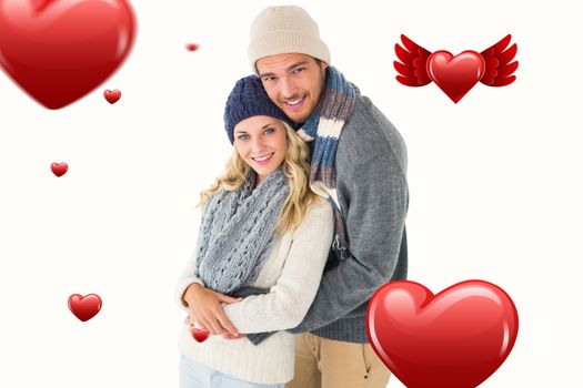 Attractive couple in winter fashion hugging against hearts
