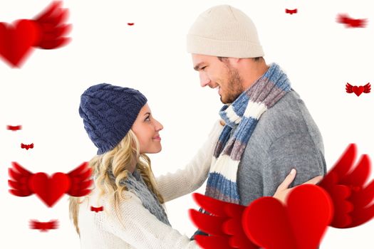 Attractive couple in winter fashion hugging against hearts