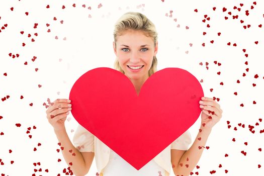 Attractive young blonde showing red heart against red love hearts