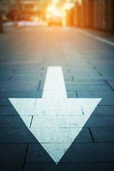 arrow on the road when sunset