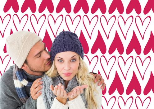 Attractive couple in winter fashion  against valentines day pattern