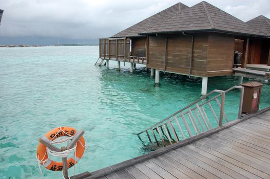 Live safer near timber pier and building at Maldives