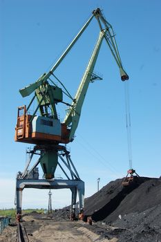 River port cargo crane loading coal, Kolyma river, Russia