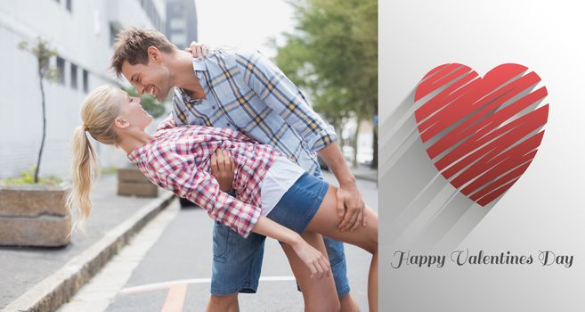 Hip romantic couple dancing in the street against cute valentines message