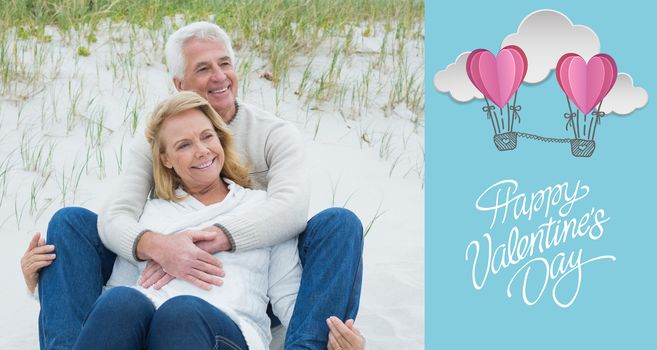 Romantic senior couple relaxing at beach against cute valentines message
