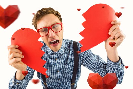 Geeky hipster holding a broken heart  against hearts