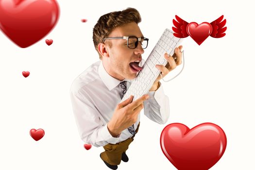 Geeky businessman licking his keyboard against hearts