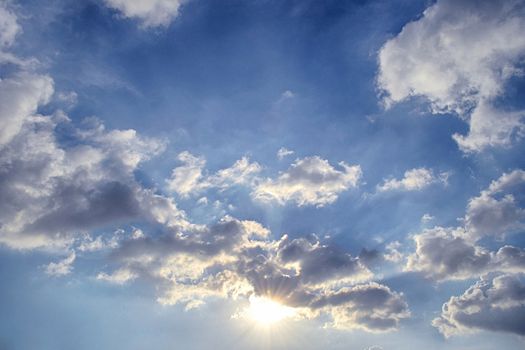 Blue sky with white cloud and sun