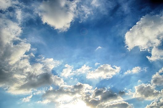 Blue sky with white cloud and sun