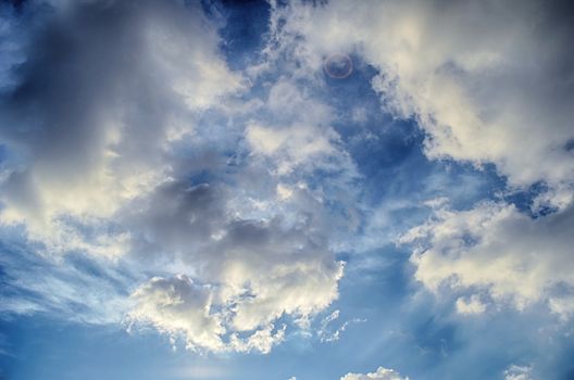 Blue sky with white cloud and sun