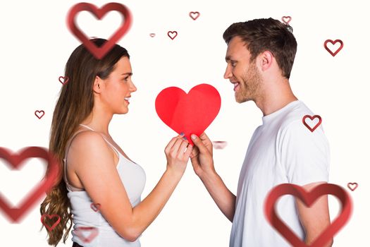 Romantic young couple holding heart against hearts