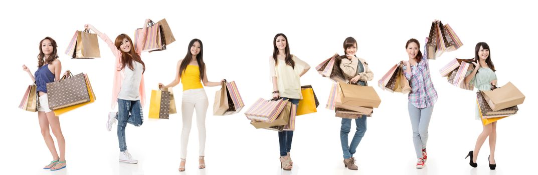 Attractive Asian women shopping and holding bags, full length portrait isolated on white background.