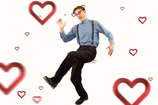 Geeky hipster walking and looking at camera against hearts