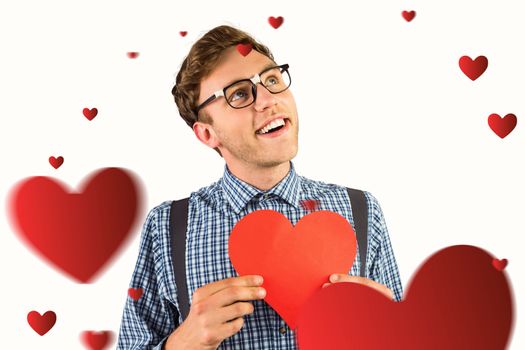 Geeky hipster holding a heart card against hearts
