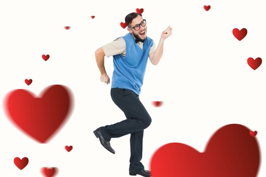 Geeky hipster dancing and smiling against hearts