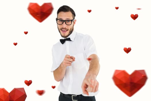 Geeky hipster pointing at camera against hearts