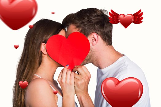 Side view of romantic couple holding heart against hearts