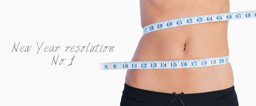 Fit belly surrounded by measuring tape on white background