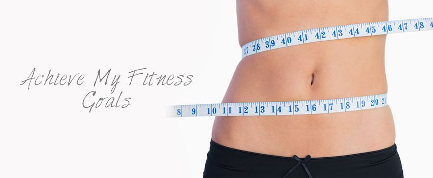 Fit belly surrounded by measuring tape on white background