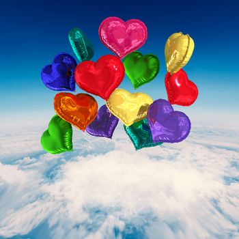 Heart balloons against blue sky over white clouds