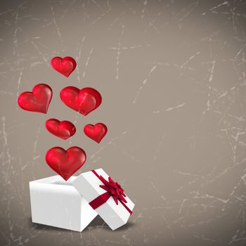 Hearts flying from box against grey background with vignette