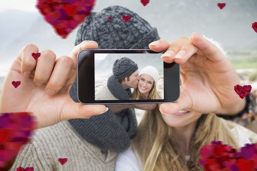 Composite image of valentines couple taking a selfie