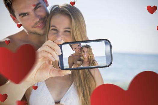 Composite image of valentines couple taking a selfie