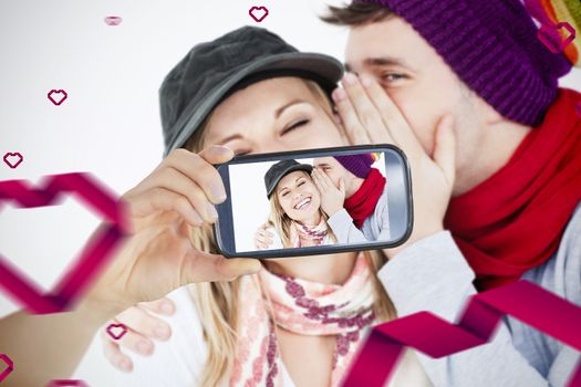 Composite image of valentines couple taking a selfie